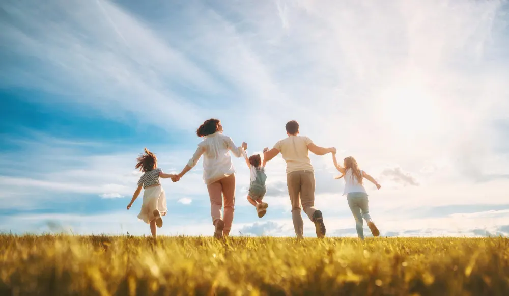 Image depicting a happy family under the sunshine, symbolizing the joy of obtaining a Family Kitap in Indonesia