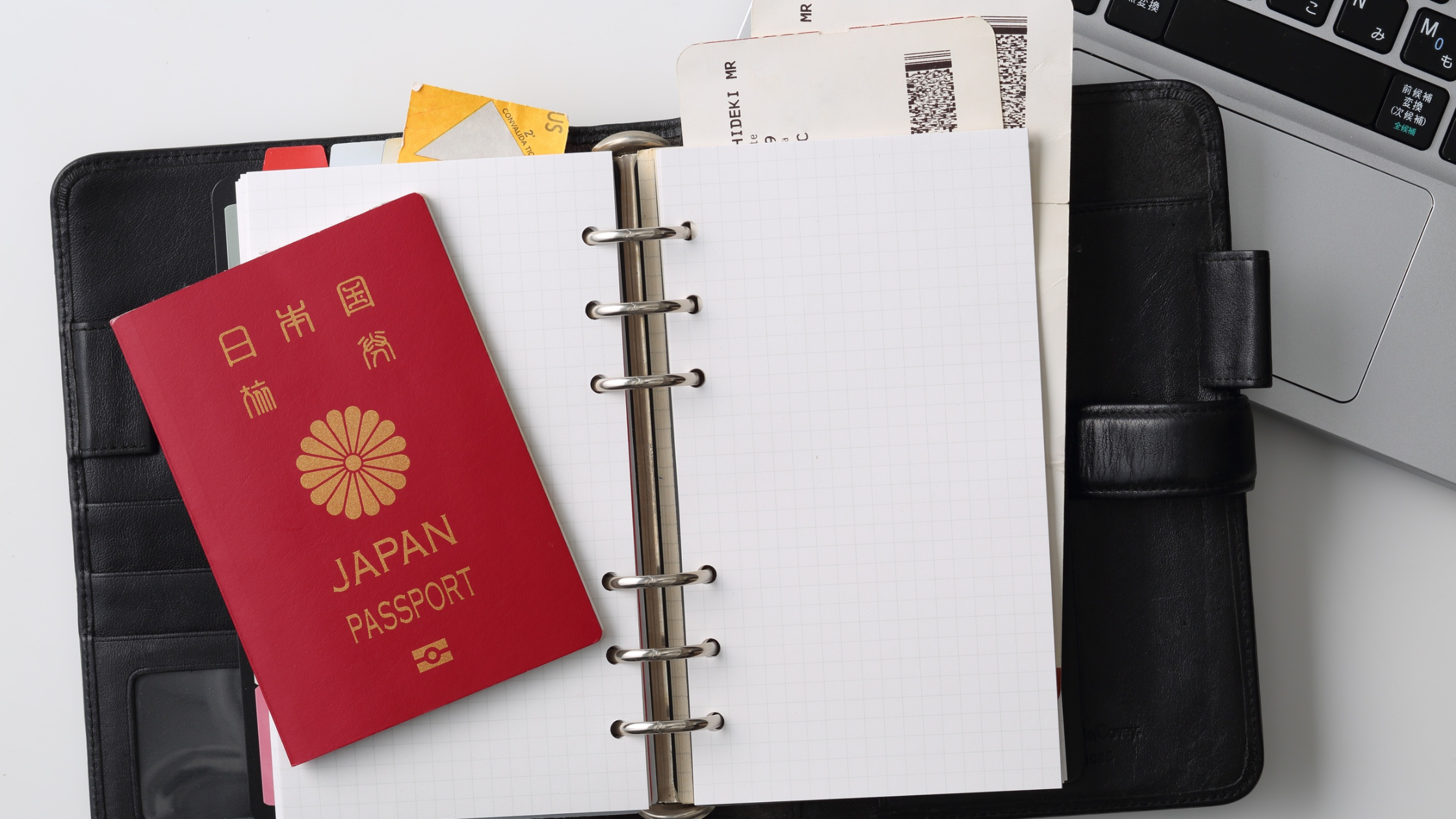Foreign passport and onward flight ticket prepared for a 60-day Bali visa application.