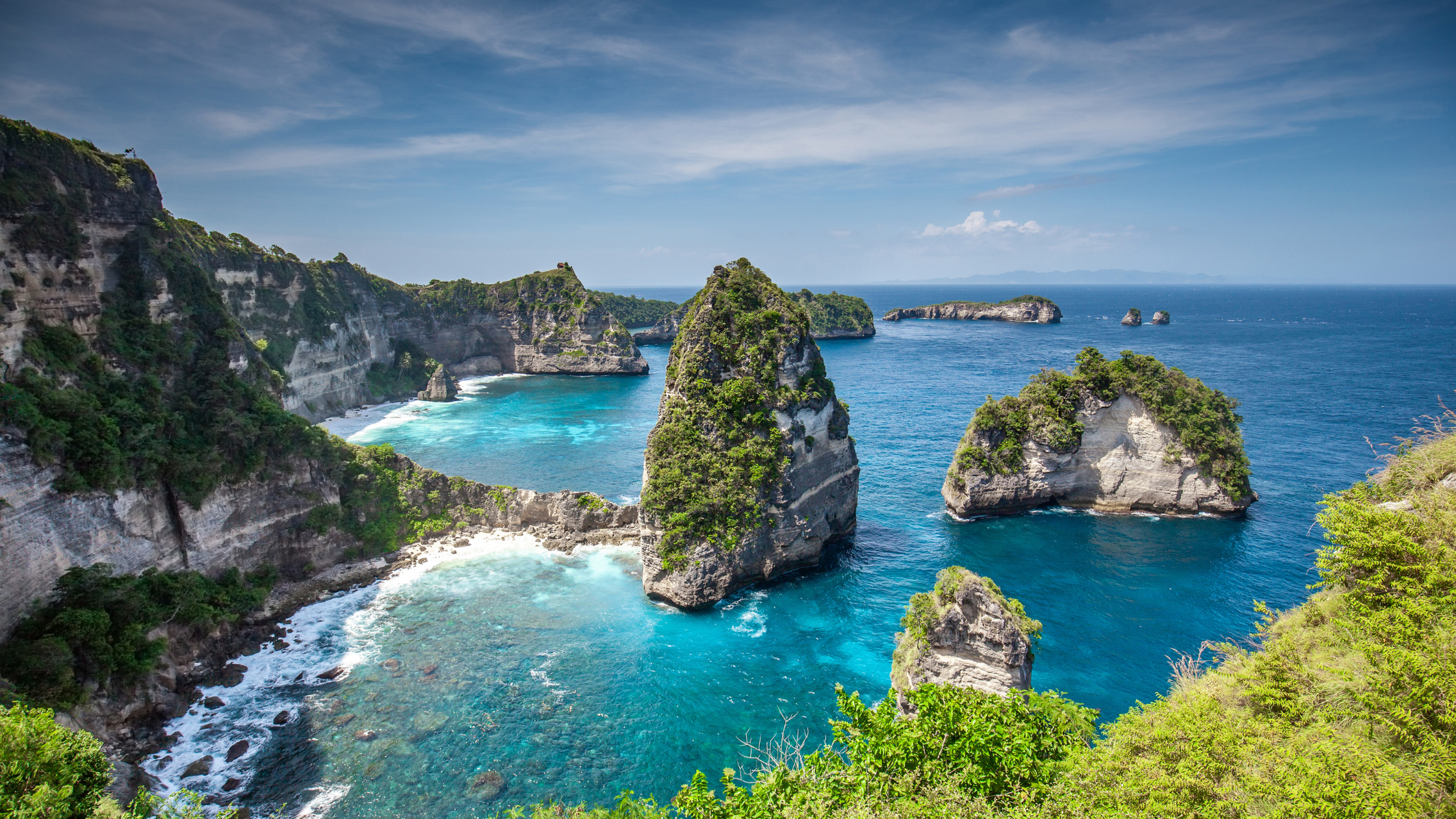 A stunning view of Tanah Lot Temple, perched on a rocky island with the ocean surrounding it, a symbol of Bali's cultural heritage.